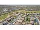 Wide aerial view of homes and community showing nearby golf course, surrounding desert landscape, and mountain views at 18199 W Buckhorn Dr, Goodyear, AZ 85338