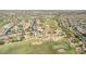 Expansive aerial view showcases well-maintained homes on a golf course, blending community living with recreational opportunities at 18199 W Buckhorn Dr, Goodyear, AZ 85338