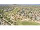 Panoramic aerial shot exhibits a community with lush golf courses, blending residential comfort and outdoor recreation at 18199 W Buckhorn Dr, Goodyear, AZ 85338