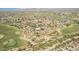 Wide aerial view of homes and community showing golf course and surrounding desert landscape at 18199 W Buckhorn Dr, Goodyear, AZ 85338