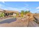 Spacious backyard offering ample seating, lounge chairs, a relaxing hammock, and a stone fireplace at 18199 W Buckhorn Dr, Goodyear, AZ 85338