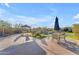 Outdoor living area with comfortable seating, lush landscaping, pool, and shade umbrellas perfect for entertaining at 18199 W Buckhorn Dr, Goodyear, AZ 85338
