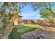 Private putting green nestled in a lush backyard with rock features and mature trees at 18199 W Buckhorn Dr, Goodyear, AZ 85338