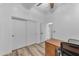 Clean bedroom showcasing wood-look floors, sliding closet doors, neutral walls, and an interior door at 18199 W Buckhorn Dr, Goodyear, AZ 85338