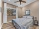Cozy bedroom featuring a large window, ceiling fan, and comfortable bedding at 18199 W Buckhorn Dr, Goodyear, AZ 85338