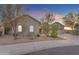 Charming single-story home featuring desert landscaping, mature trees, and a welcoming facade with ample parking at 18199 W Buckhorn Dr, Goodyear, AZ 85338
