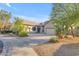 Well-kept home with a desert landscape, large driveway, and an attached three-car garage, providing ample space at 18199 W Buckhorn Dr, Goodyear, AZ 85338