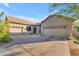 Spacious three-car garage with ample driveway, complementing the well-maintained home exterior and landscaping at 18199 W Buckhorn Dr, Goodyear, AZ 85338