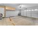 Spacious garage featuring a neutral color palette, paneled garage door, and built-in storage cabinets at 18199 W Buckhorn Dr, Goodyear, AZ 85338