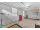 Well-lit garage equipped with storage cabinets, windows, and a toolbox, provides a functional and organized space at 18199 W Buckhorn Dr, Goodyear, AZ 85338