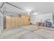 Large garage with built-in storage cabinets, garage door, and access door, offering ample space for vehicles and storage at 18199 W Buckhorn Dr, Goodyear, AZ 85338