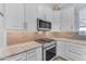 Well-equipped kitchen featuring granite countertops, stainless steel appliances, and a modern design at 18199 W Buckhorn Dr, Goodyear, AZ 85338