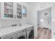 Well-lit laundry room features modern washer and dryer, storage cabinets, and convenient access to the home's interior at 18199 W Buckhorn Dr, Goodyear, AZ 85338