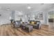 Open concept living room with hardwood floors and ample seating, perfect for entertaining at 18199 W Buckhorn Dr, Goodyear, AZ 85338