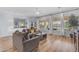Spacious living area with hardwood floors, large windows and cozy gray sofa at 18199 W Buckhorn Dr, Goodyear, AZ 85338