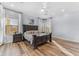 Serene main bedroom featuring a dark wood bed, soft lighting, and two windows at 18199 W Buckhorn Dr, Goodyear, AZ 85338