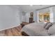 Large main bedroom with wood floors, neutral color scheme and view to the patio at 18199 W Buckhorn Dr, Goodyear, AZ 85338