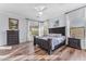 Spacious main bedroom with wood floors, dresser, nightstands and ceiling fan at 18199 W Buckhorn Dr, Goodyear, AZ 85338