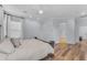 Large main bedroom with wood floors, fan and view to other rooms at 18199 W Buckhorn Dr, Goodyear, AZ 85338