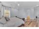 Spacious main bedroom with wood floors, fan and view to other rooms at 18199 W Buckhorn Dr, Goodyear, AZ 85338