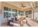 Inviting covered patio featuring brick pavers, a ceiling fan, and comfortable seating area for outdoor relaxation at 18199 W Buckhorn Dr, Goodyear, AZ 85338