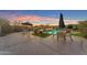 Backyard oasis with a sparkling pool, sun loungers, and dining area, perfect for enjoying outdoor relaxation at 18199 W Buckhorn Dr, Goodyear, AZ 85338
