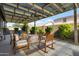 Spacious backyard patio with ample seating under a stylish, covered structure at 18837 W San Juan Ave, Litchfield Park, AZ 85340
