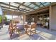 Expansive backyard patio featuring covered seating and an outdoor cooking area at 18837 W San Juan Ave, Litchfield Park, AZ 85340