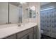 Bathroom featuring gray vanity with brushed nickel faucet and a shower with a blue patterned shower curtain at 18837 W San Juan Ave, Litchfield Park, AZ 85340