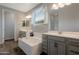 Luxurious bathroom boasts double sinks, a soaking tub, and modern fixtures at 18837 W San Juan Ave, Litchfield Park, AZ 85340