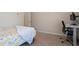 Well-lit bedroom featuring a cozy bed, desk, and great natural light at 18837 W San Juan Ave, Litchfield Park, AZ 85340