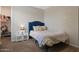 Comfortable bedroom with a nicely decorated bed, and an organized walk-in closet at 18837 W San Juan Ave, Litchfield Park, AZ 85340