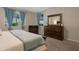 Well-lit bedroom featuring carpet flooring and modern furnishings at 18837 W San Juan Ave, Litchfield Park, AZ 85340