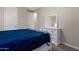 Bedroom features white dresser, carpet, a comfortable bed with a soft gray blanket, and ample natural light at 18837 W San Juan Ave, Litchfield Park, AZ 85340