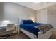 Comfortable bedroom with a desk, neutral walls, carpet, a fan and a comfortable bed with a plush blue comforter at 18837 W San Juan Ave, Litchfield Park, AZ 85340