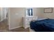 Bedroom featuring white dresser, blue curtains, carpet, and a comfortable bed with a plush blue comforter at 18837 W San Juan Ave, Litchfield Park, AZ 85340