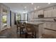 Open kitchen featuring an island with bar seating, stylish pendant lights, and modern appliances at 18837 W San Juan Ave, Litchfield Park, AZ 85340