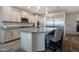 Kitchen island with granite countertop and stainless steel refrigerator at 18837 W San Juan Ave, Litchfield Park, AZ 85340