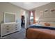 Spacious main bedroom with walk-in closet, neutral walls, carpet and soft natural light from the window at 18837 W San Juan Ave, Litchfield Park, AZ 85340