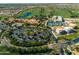 Wide aerial shot of a community featuring a golf course, a pool and tennis courts, and residential housing at 199 E Tangerine Path, Queen Creek, AZ 85140