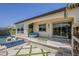 An outdoor patio features a cozy conversation area, a vibrant green wall, and views of the pool at 199 E Tangerine Path, Queen Creek, AZ 85140
