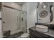 A modern bathroom features a glass-enclosed shower with vertical white tiles and a stylish vessel sink at 199 E Tangerine Path, Queen Creek, AZ 85140