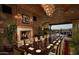 Formal dining room featuring a long table set for dinner, a fireplace, and views of the outdoors at 199 E Tangerine Path, Queen Creek, AZ 85140