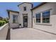 Exterior view of the home's entrance featuring a decorative door and paved courtyard at 199 E Tangerine Path, Queen Creek, AZ 85140