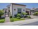 Front exterior of a home with a well-manicured lawn, lush bushes, and paved driveway at 199 E Tangerine Path, Queen Creek, AZ 85140