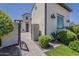 Home exterior with a gated courtyard entry and manicured landscaping at 199 E Tangerine Path, Queen Creek, AZ 85140