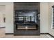 Modern fireplace with black tile surround and integrated mirror, creating a stylish focal point at 199 E Tangerine Path, Queen Creek, AZ 85140