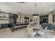 A kitchen with an oversized island, bar seating and stainless appliances is adjacent to the dining area at 199 E Tangerine Path, Queen Creek, AZ 85140