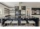 Modern kitchen features an island with seating, a stainless steel range hood, and ample cabinet space at 199 E Tangerine Path, Queen Creek, AZ 85140