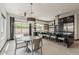 An open concept kitchen features an island with bar stool seating between the sink area and dining area at 199 E Tangerine Path, Queen Creek, AZ 85140